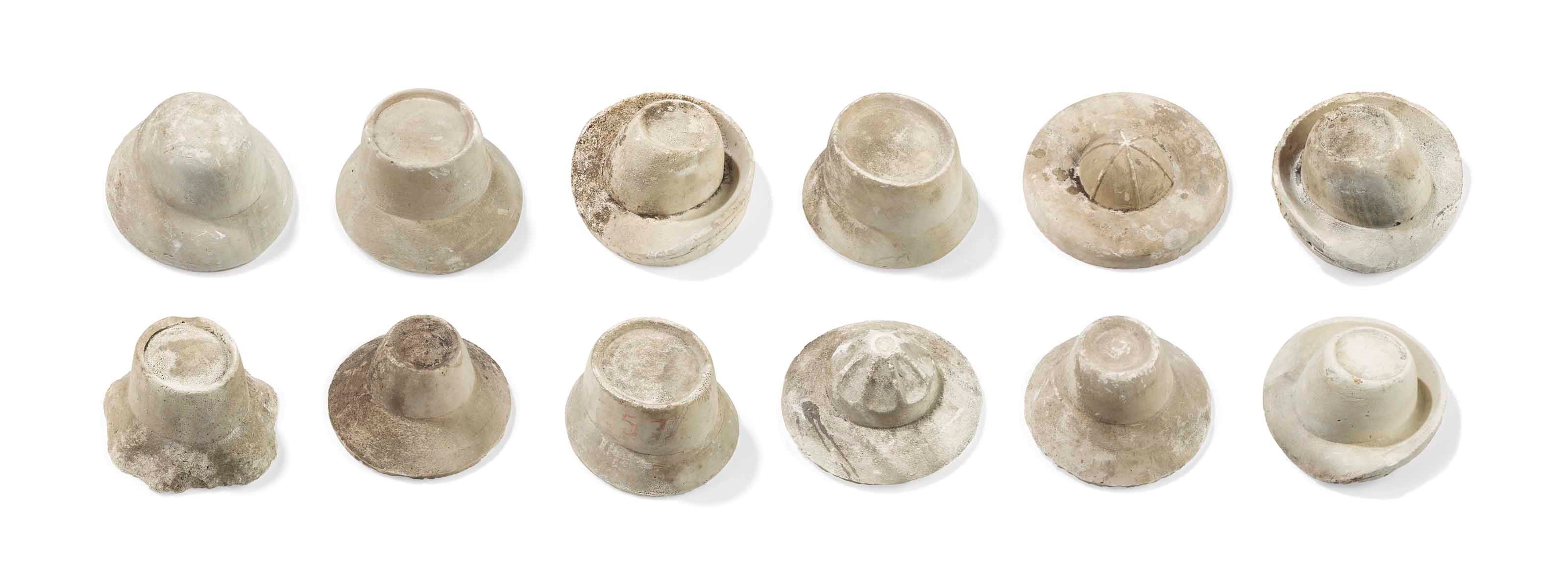 A GROUP OF TWELVE PLASTER HAT MOULDS