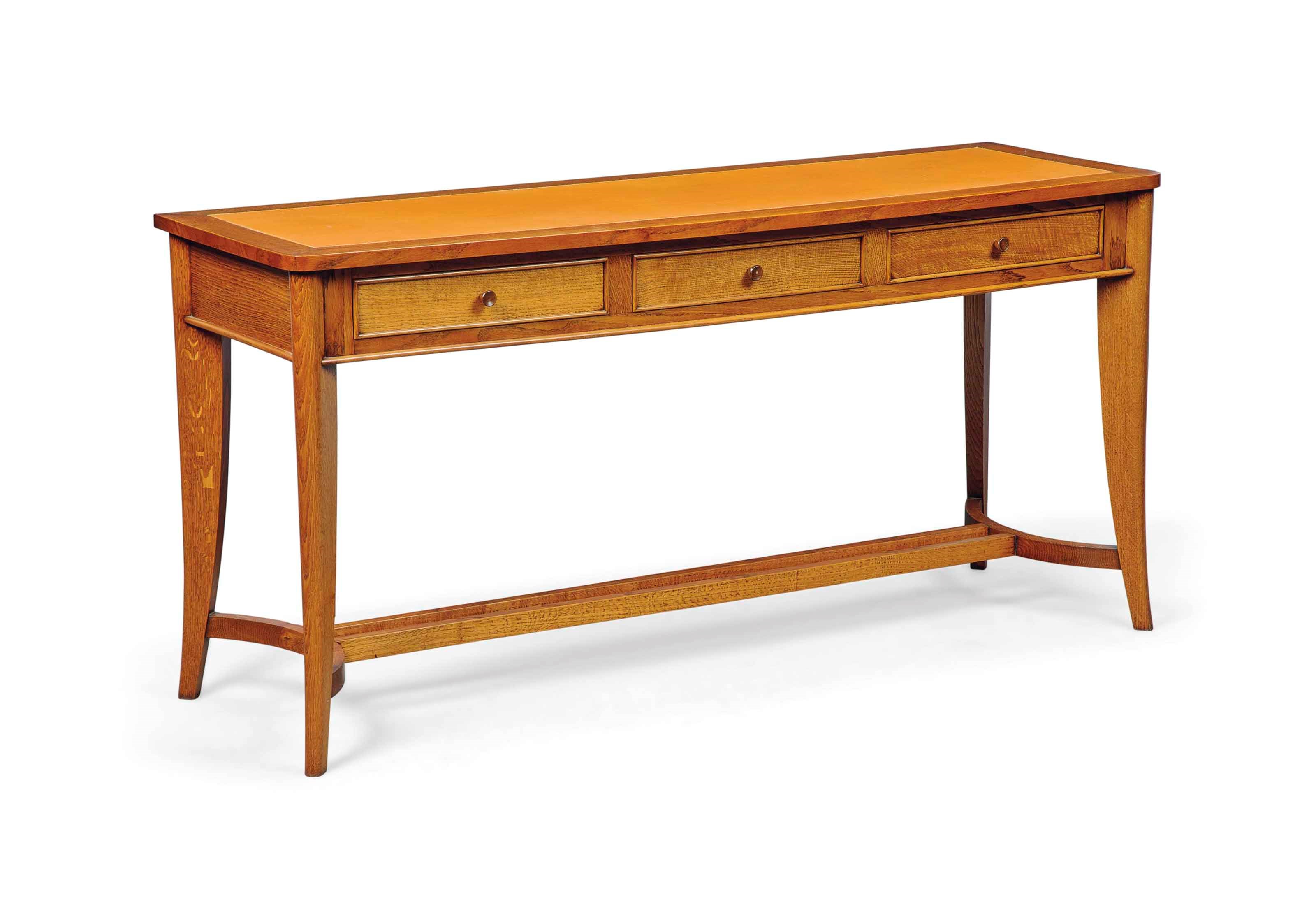 AN OAK CONSOLE WITH LEATHER INSET, IN THE MANNER OF JEAN PASCAUD (1903-1996)