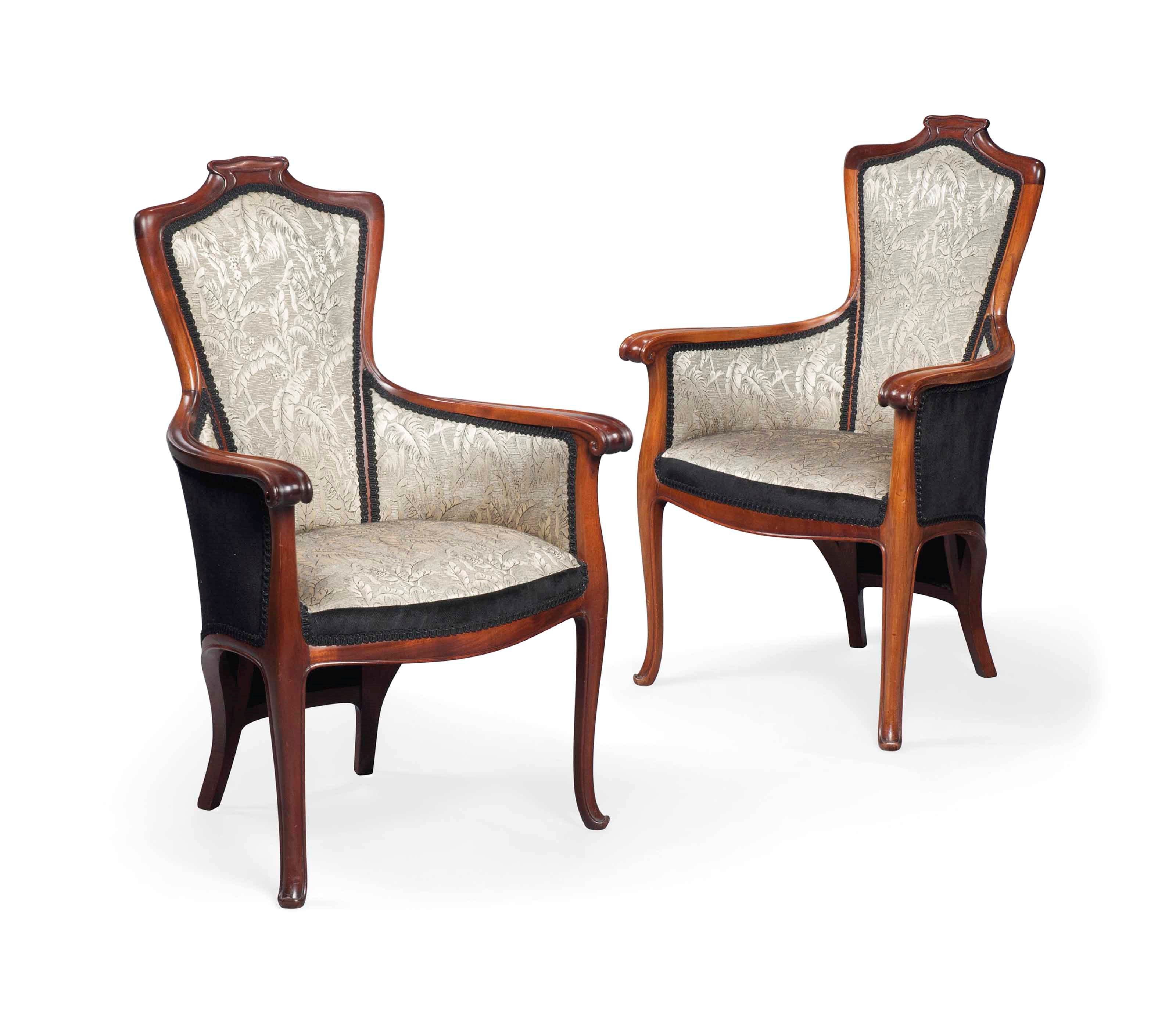 A PAIR OF EDOUARD COLONNA (1862-1948) MAHOGANY AND UPHOLSTERED SALON ARM CHAIRS