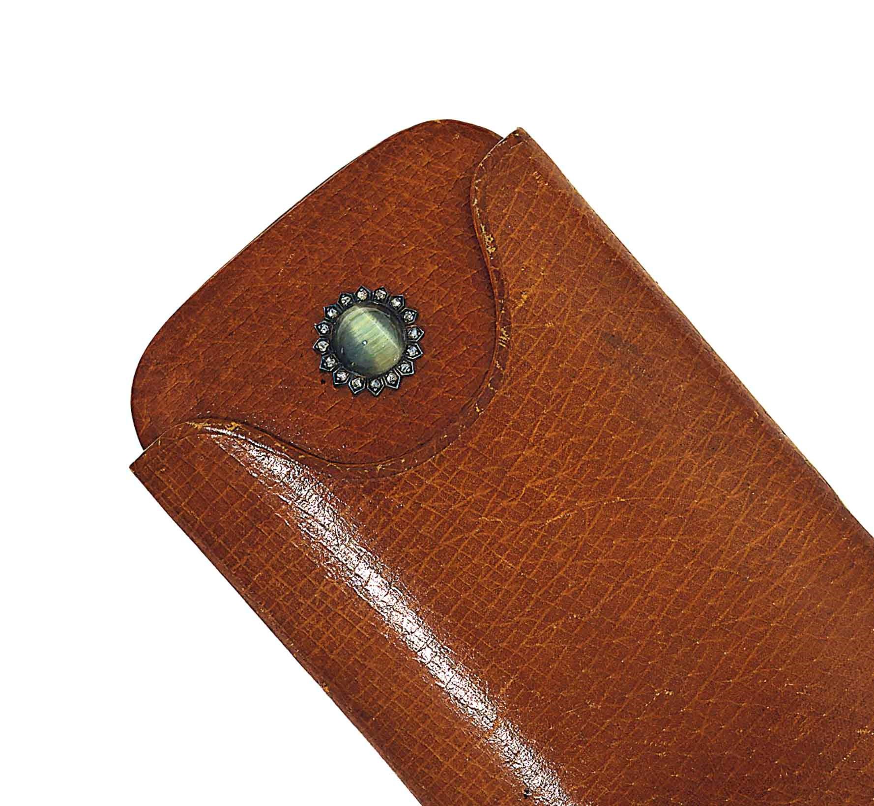 A late 19th century diamond and hardstone set leather cigarette case