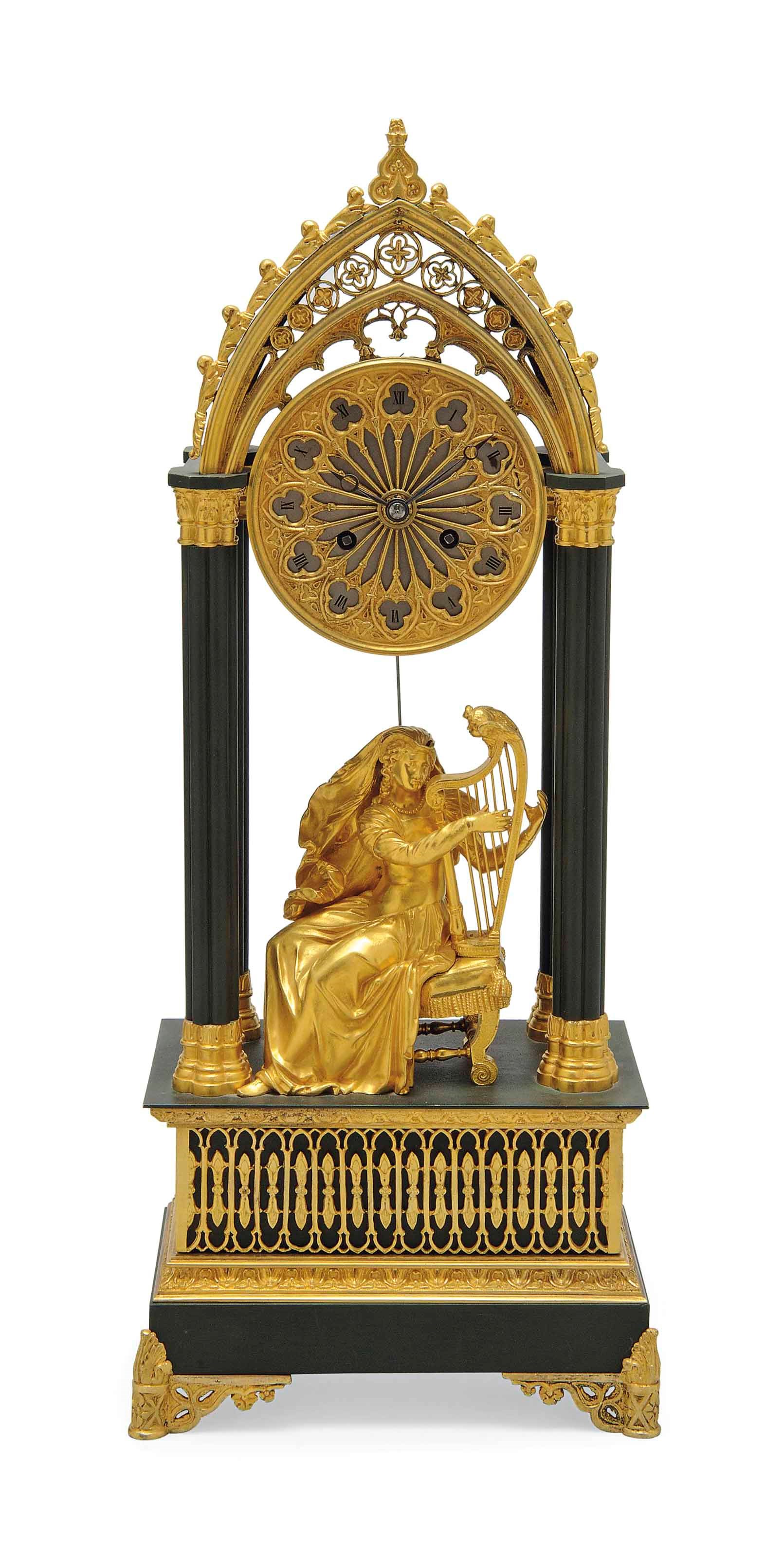 A LOUIS-PHILIPPE GOTHIC-REVIVAL GILT AND PATINATED BRONZE STRIKING MANTEL CLOCK