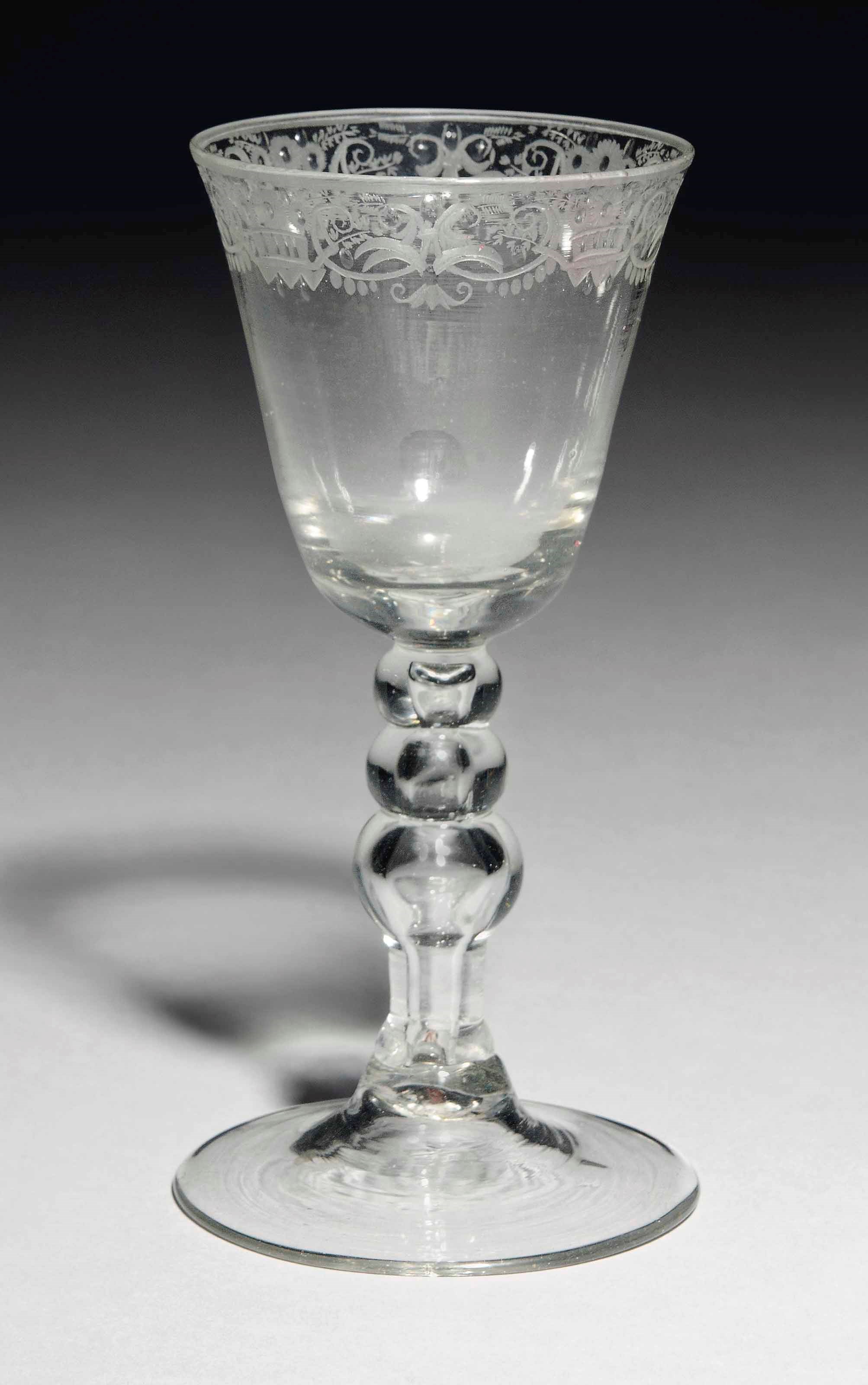 A DUTCH-ENGRAVED BALUSTROID DRINKING GLASS