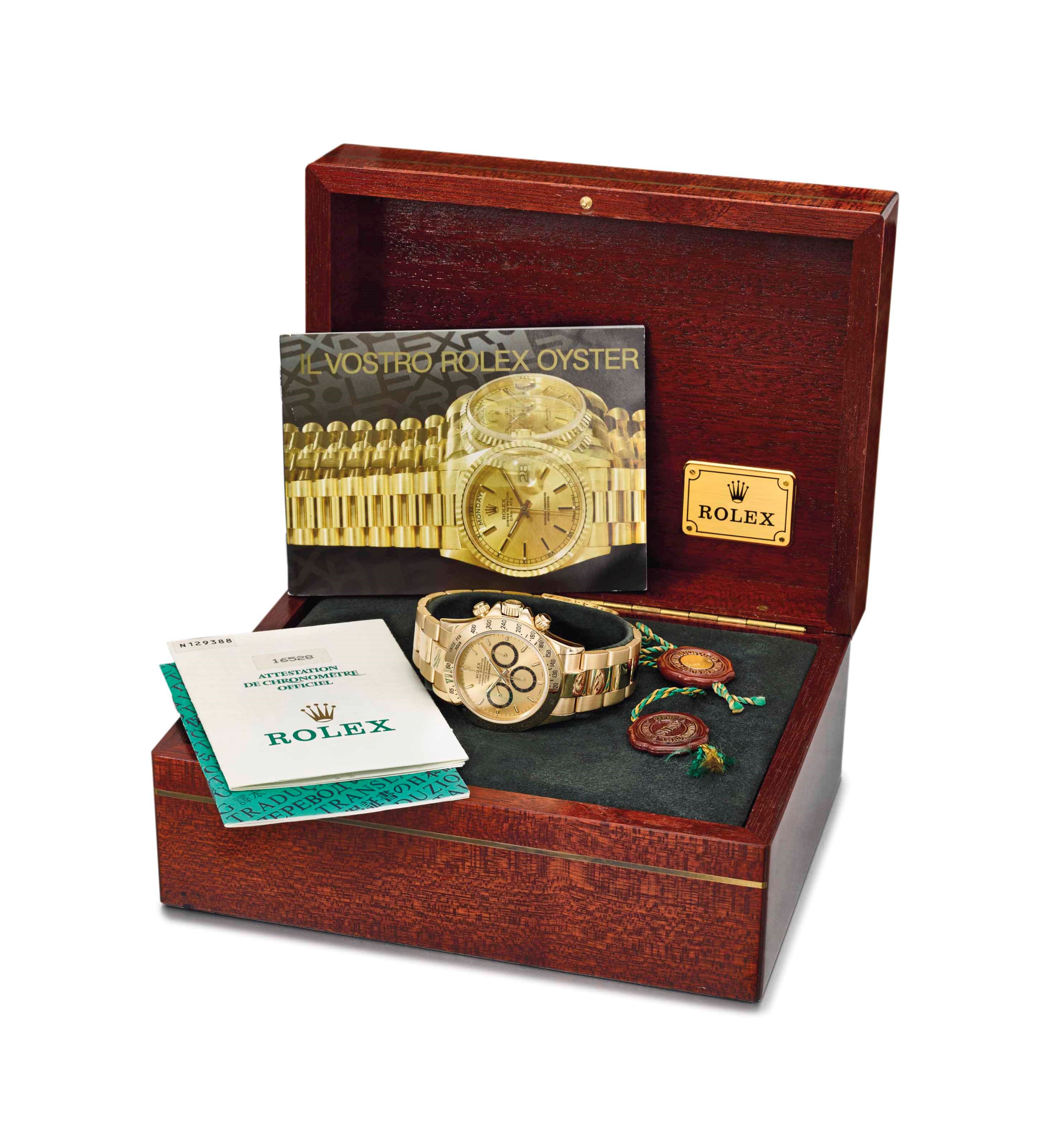 Rolex. A fine and highly attractive 18K gold automatic chronograph wristwatch with bracelet, Garantie and box