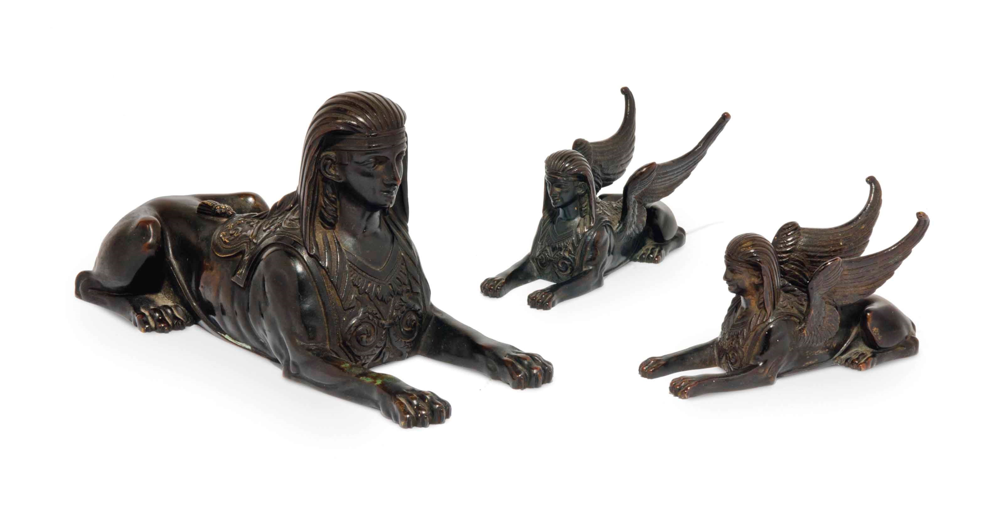 A SET OF THREE FRENCH BRONZE RECUMBENT SPHINXES