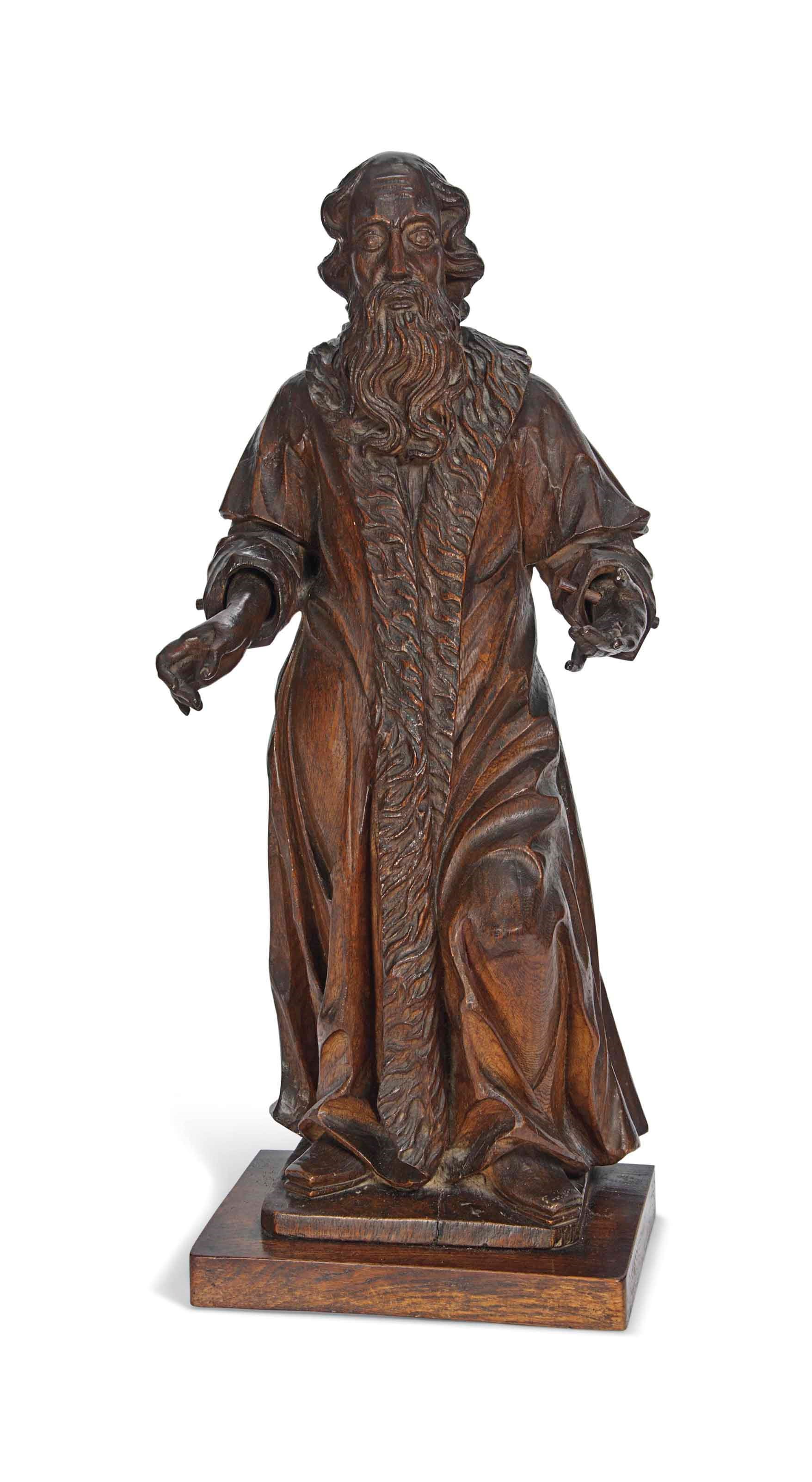 A FLEMISH OAK SCULPTURE OF A MAN WEARING A FUR-TRIMMED COAT, POSSIBLY SAINT JOSEPH