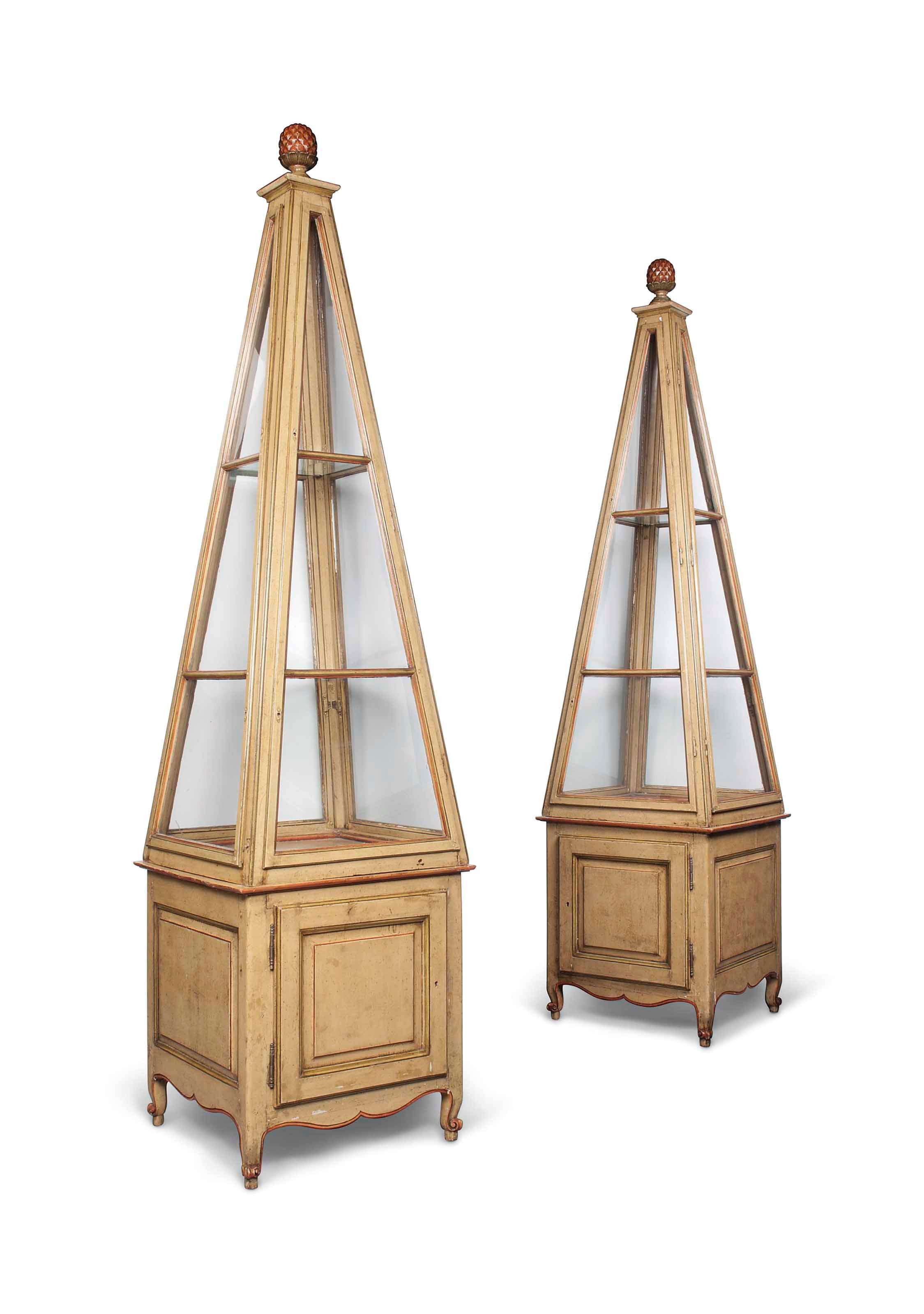 A PAIR OF FRENCH STYLE POLYCHROME-PAINTED 'OBELISK' DISPLAY CABINETS