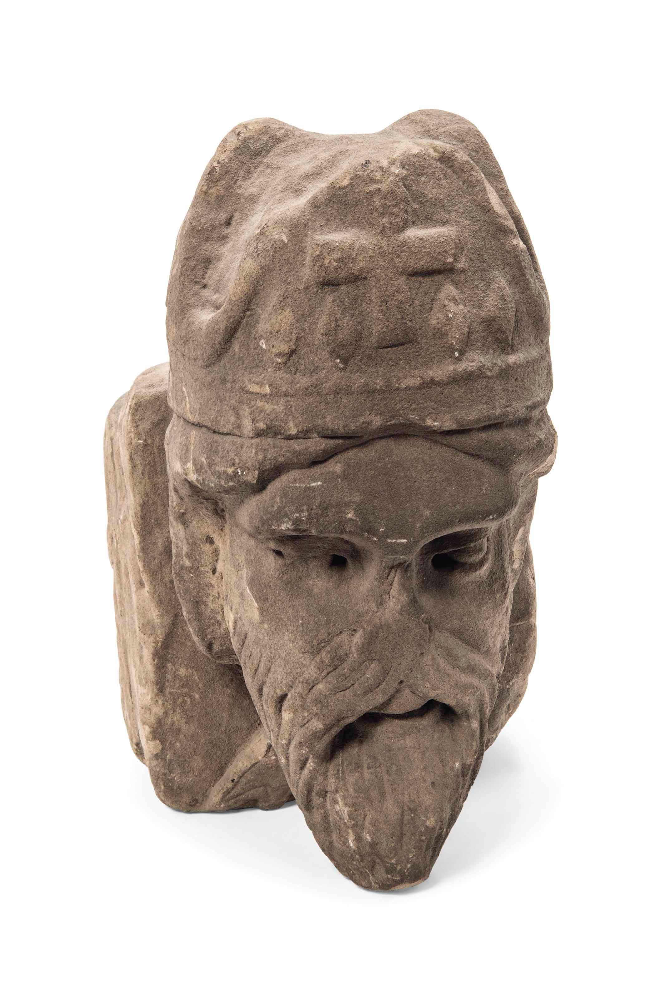 AN ENGLISH SANDSTONE CORBEL BUST OF A BISHOP