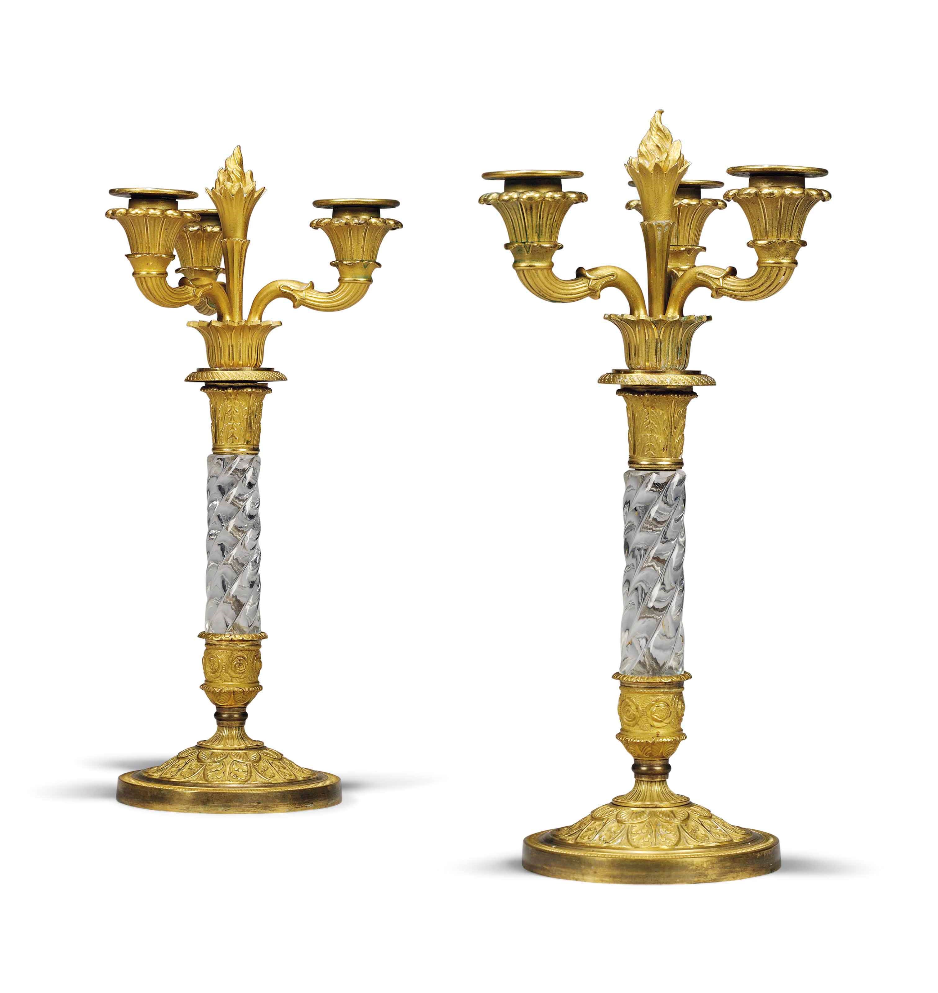 A PAIR OF NORTH EUROPEAN ORMOLU AND GLASS MOUNTED THREE LIGHT CANDELABRA