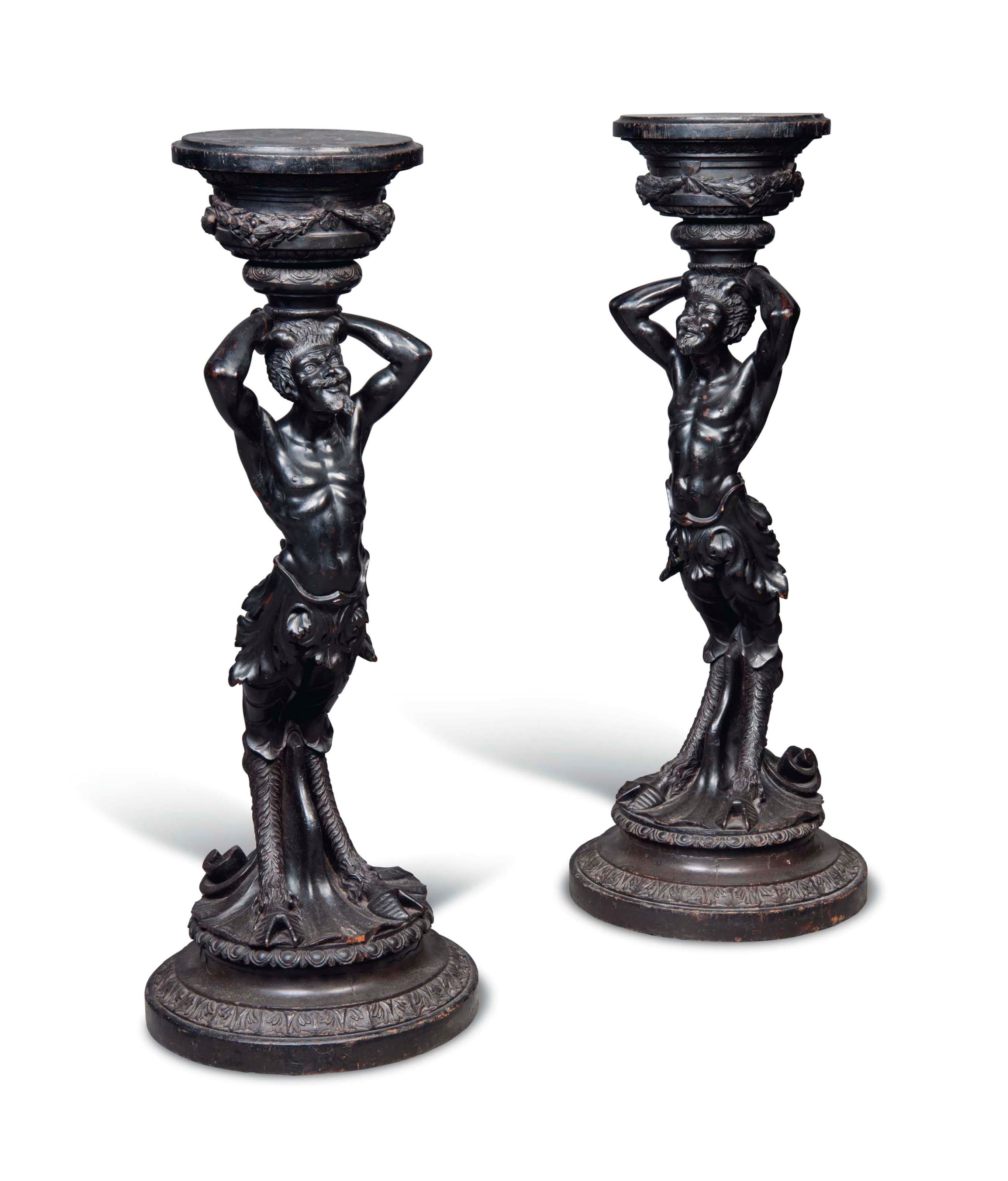 A PAIR OF NORTH EUROPEAN EBONISED SATYR TORCHERES