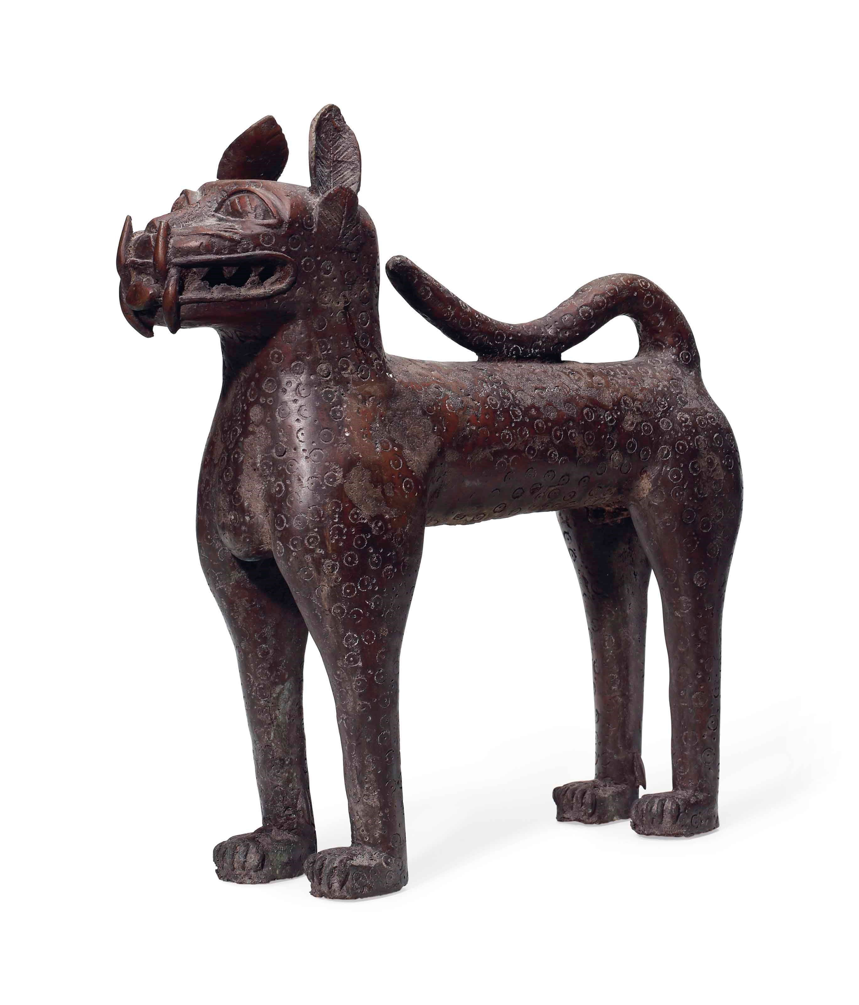 A BENIN-STYLE BRONZE MODEL OF A LEOPARD