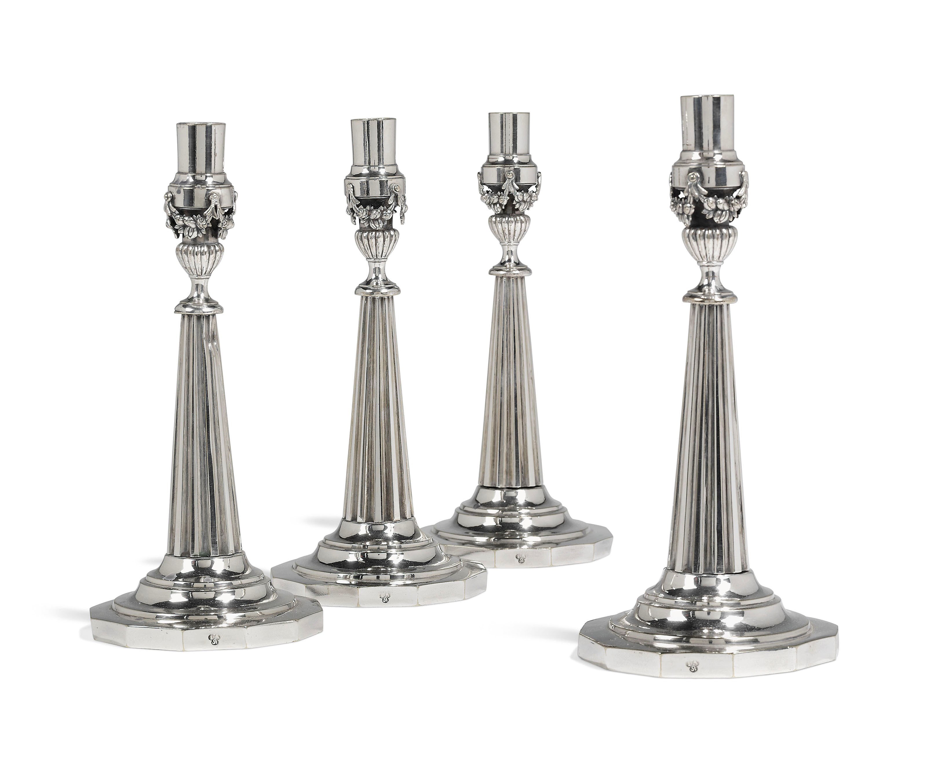 A SET OF FOUR GERMAN SILVER-PLATED CANDLESTICKS