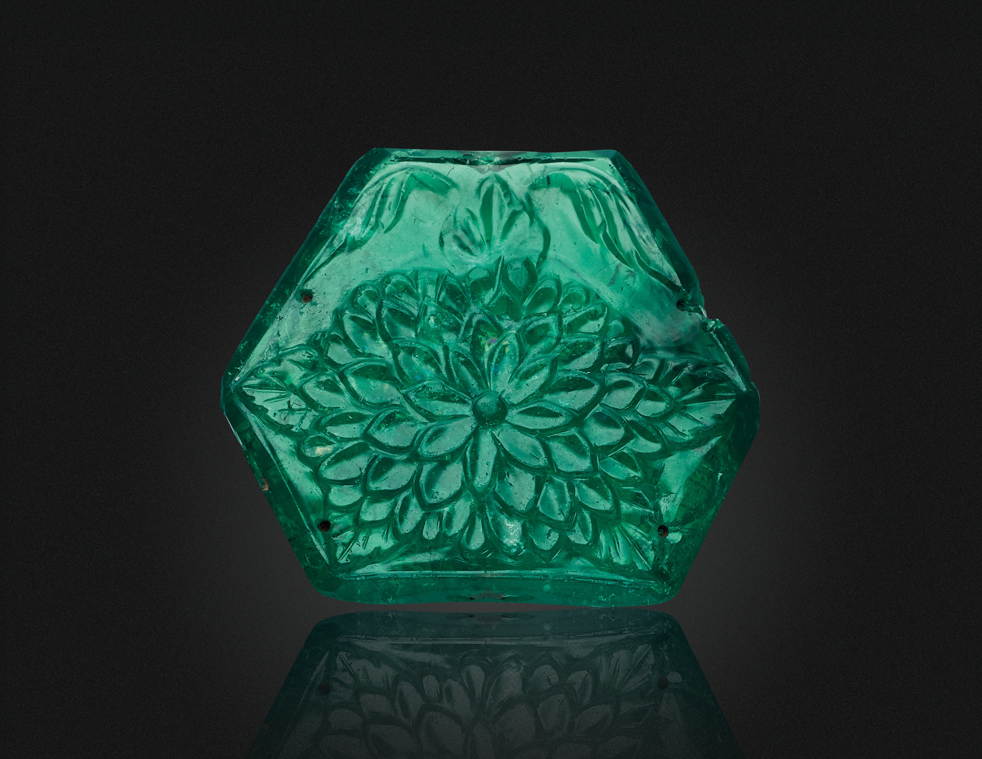 A CARVED EMERALD