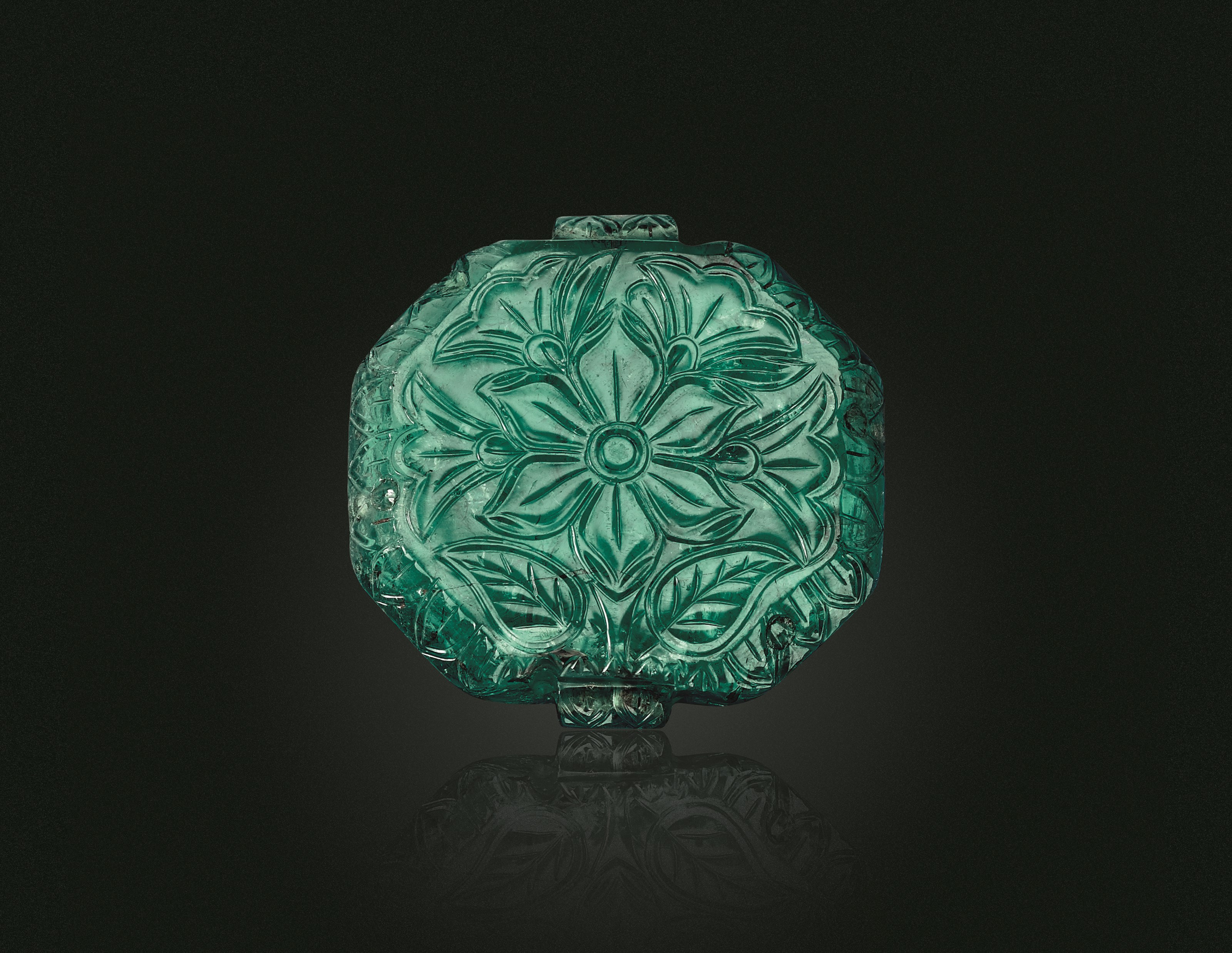 A CARVED EMERALD