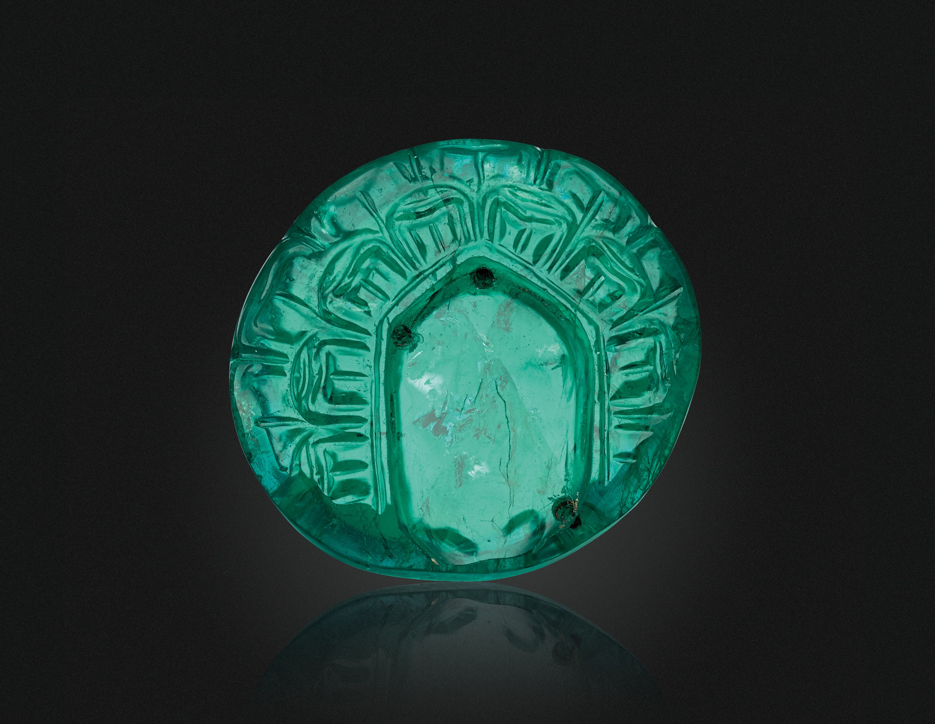 A CARVED EMERALD