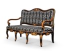 A SPANISH PARCEL-GILT AND EBONISED THREE-SEAT CANAPE