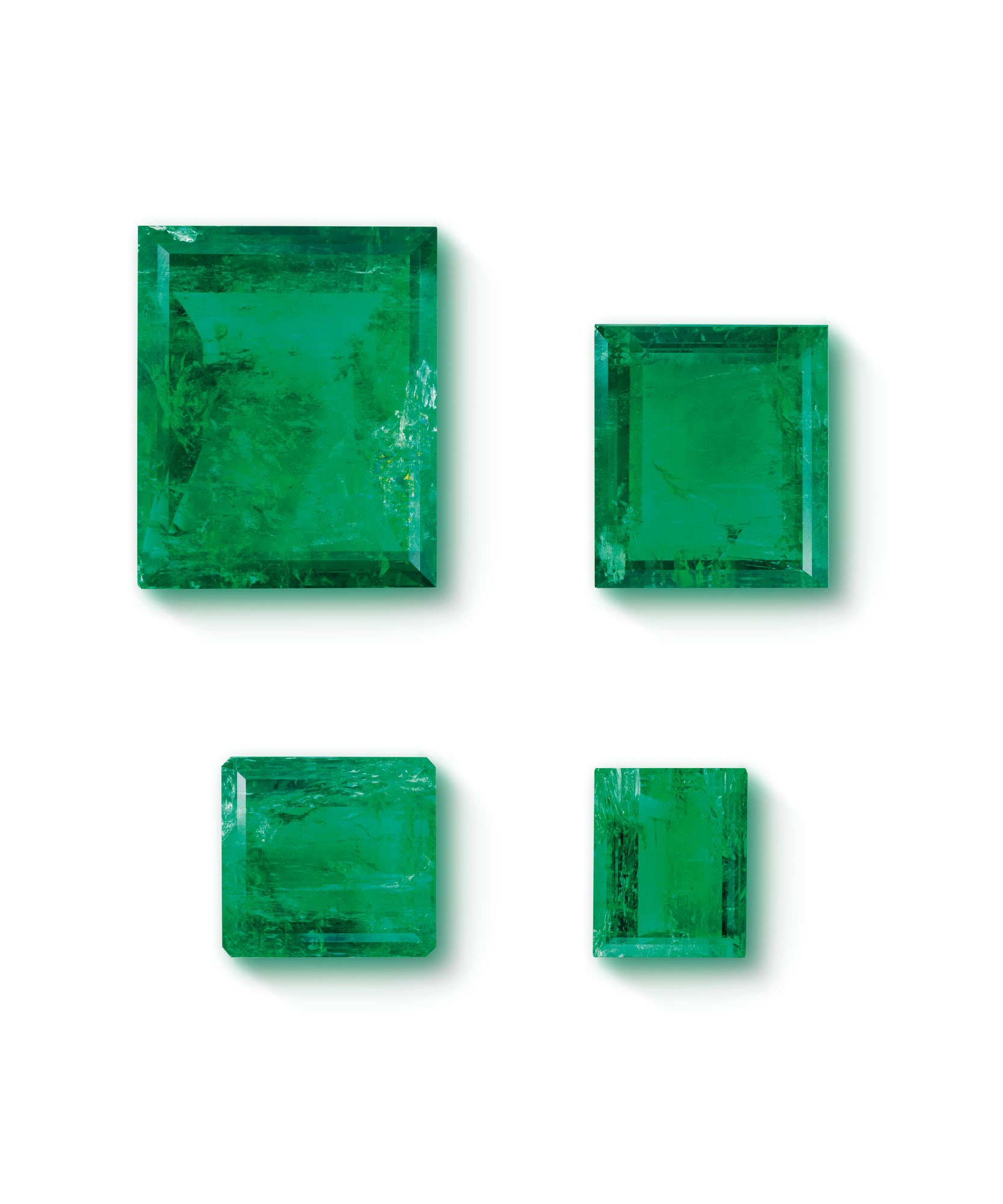 FOUR UNMOUNTED EMERALDS